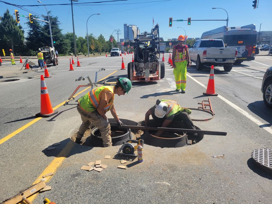 Crew setting a casting on 104 Ave